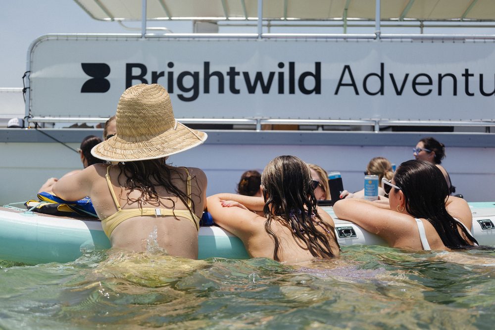 Guests in the water beside the Brightwild Adventures boat