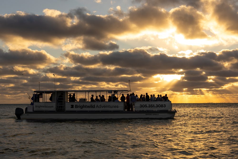 The boat full of guests at sunset