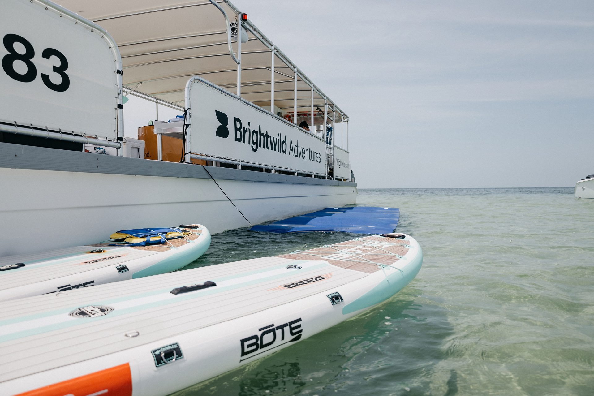 Paddleboards lined up beside the boat