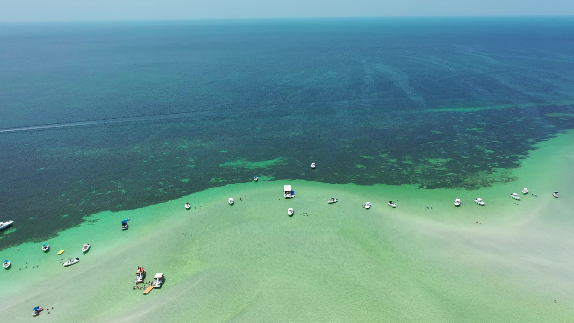 Aerial view of boats anchored along the edge of a Key West sandbar